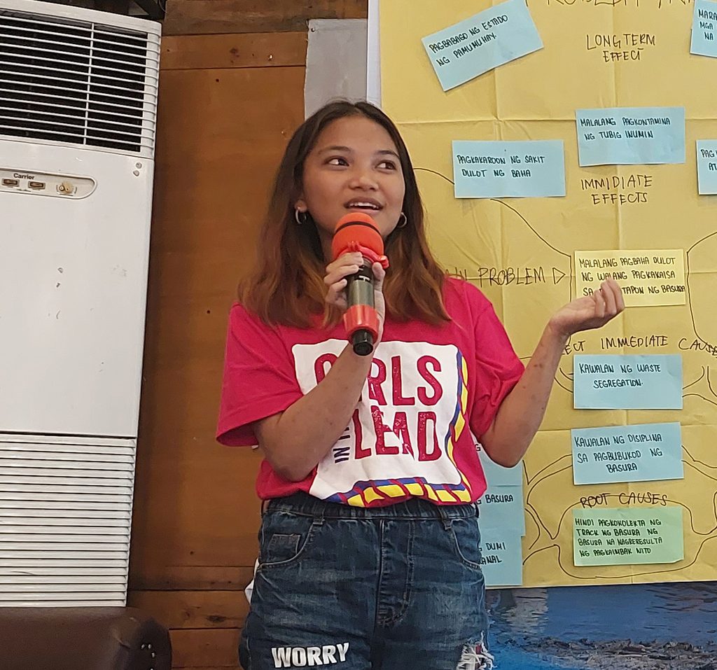 Aires speaking into a microphone.