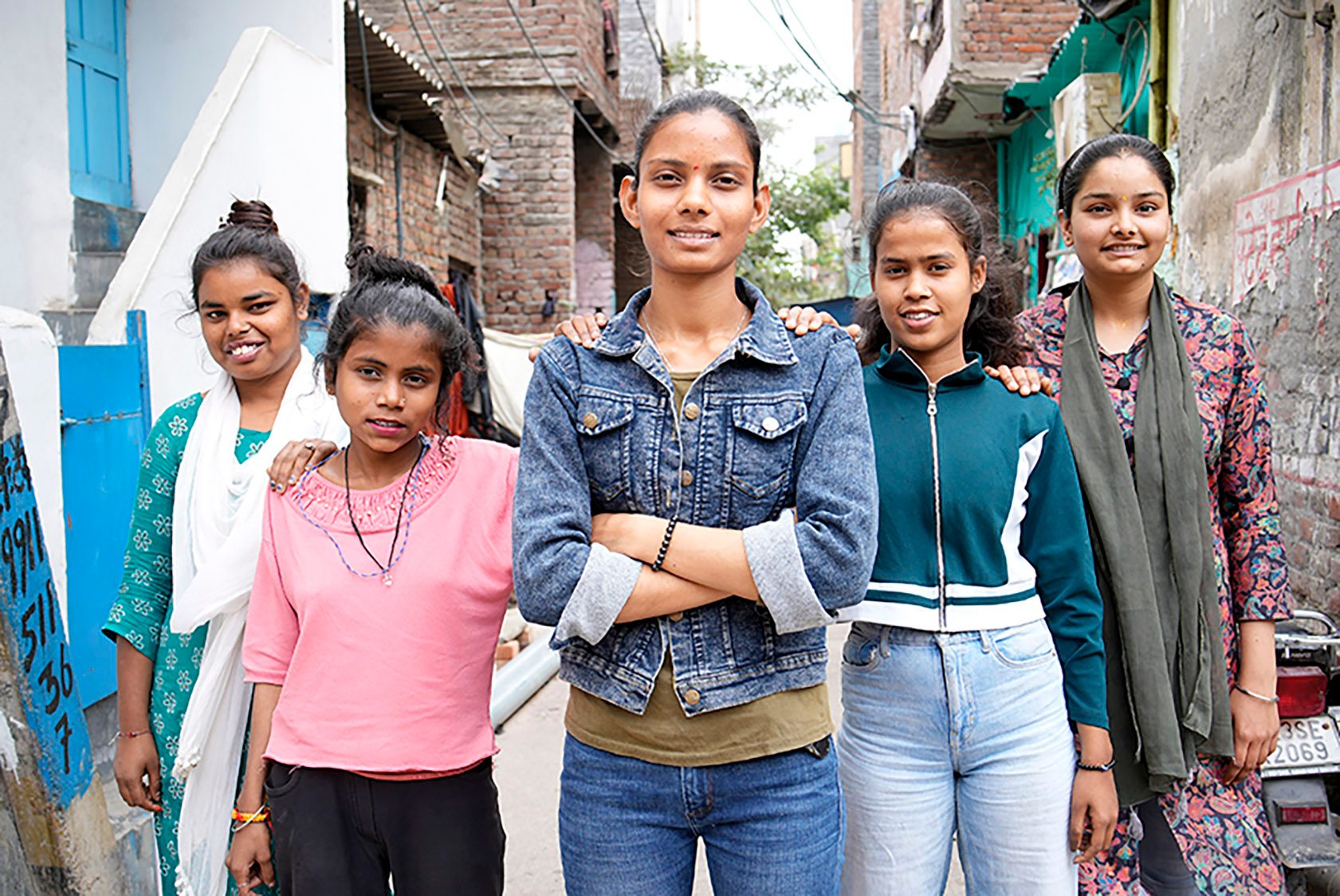 Five girls confidently standing in a row